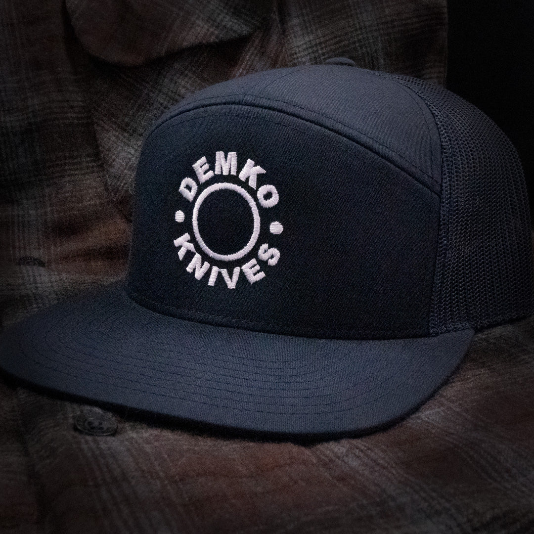 Navy blue hat featuring a white Demko Knives embroidered logo.