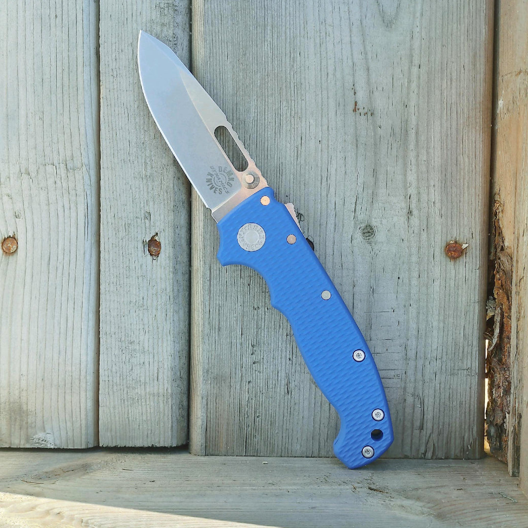 AD20 Demko Knives Dynamics folding knife with a blue G10 handle and Demko Knives Dynamics logo etched on the blade.