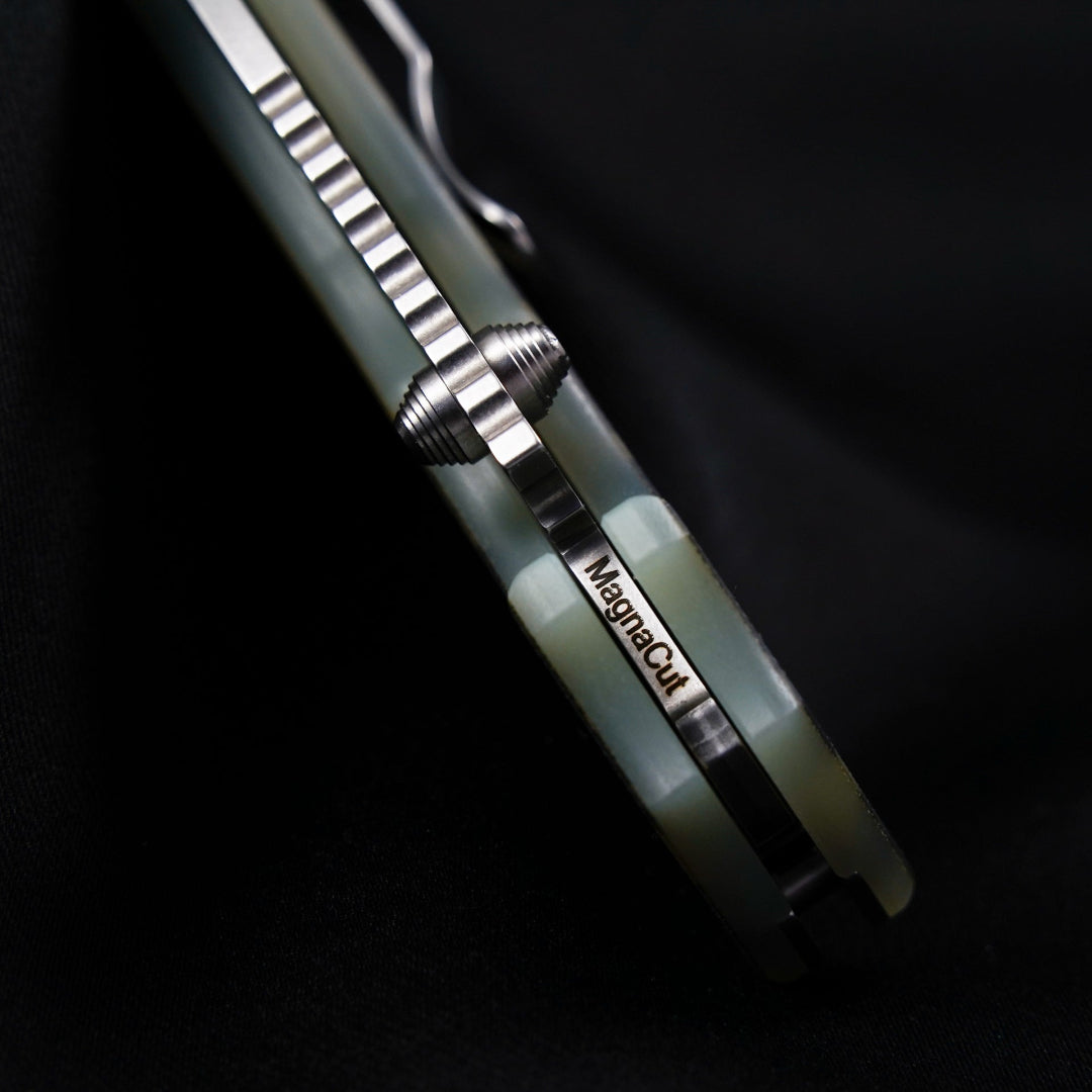 American Made folding knife in the closed position showing the MagnaCut steel name on the inside of the spine.