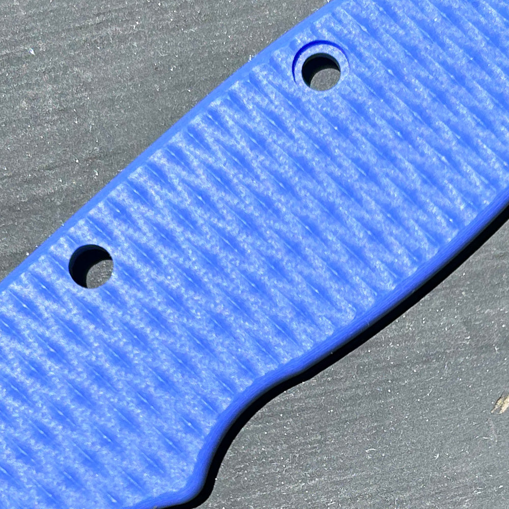 Close-up view of a blue2 G10 handle replacement scale with a milled texture pattern.
