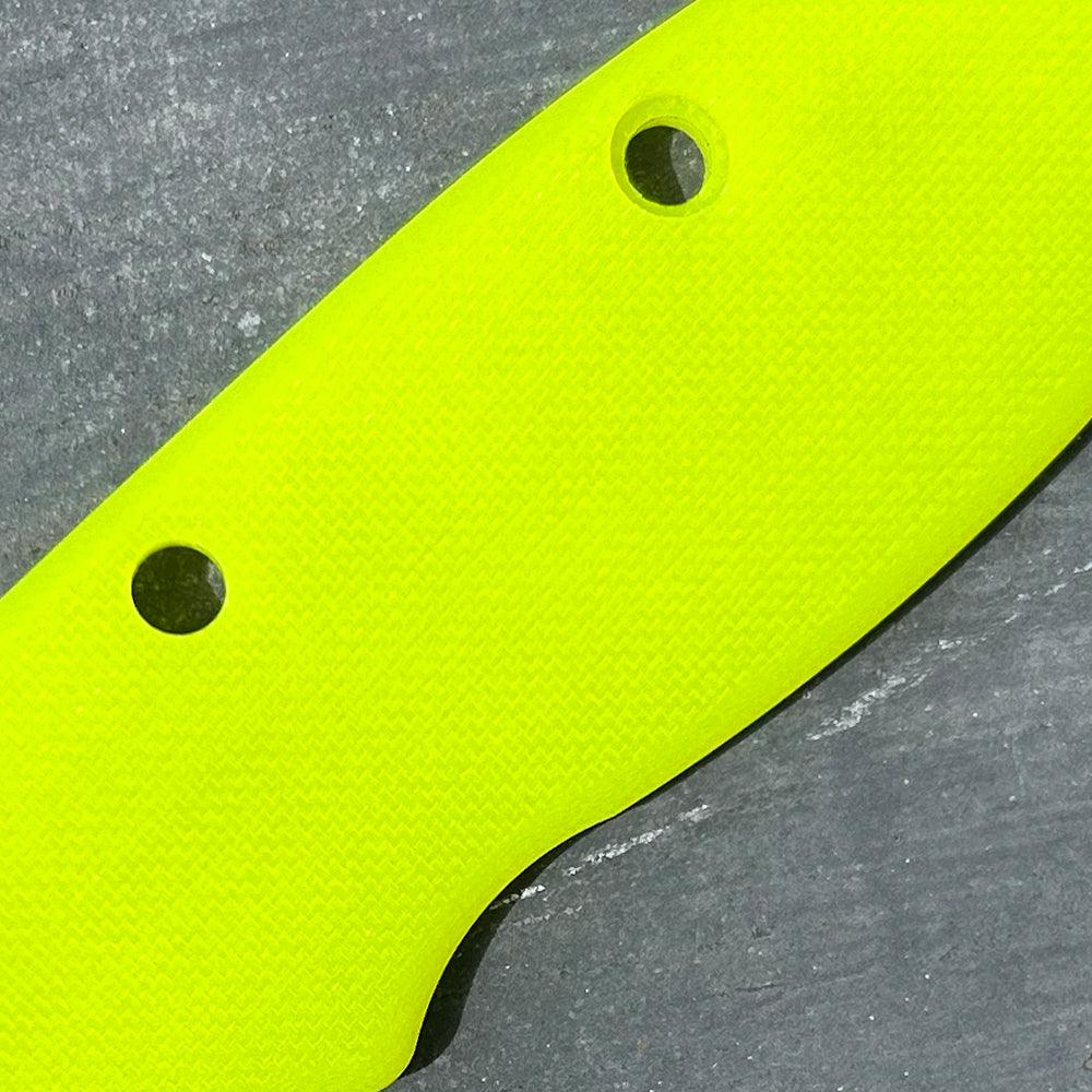 Close-up of day glow peel ply texture G10 replacement scales for AD20 folding knife.