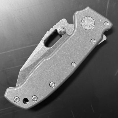 Demko AD20 Compact Knife with MagnaCut steel blade, smooth titanium handle, and Demko Shark-Lock, back side closed view on dark background.