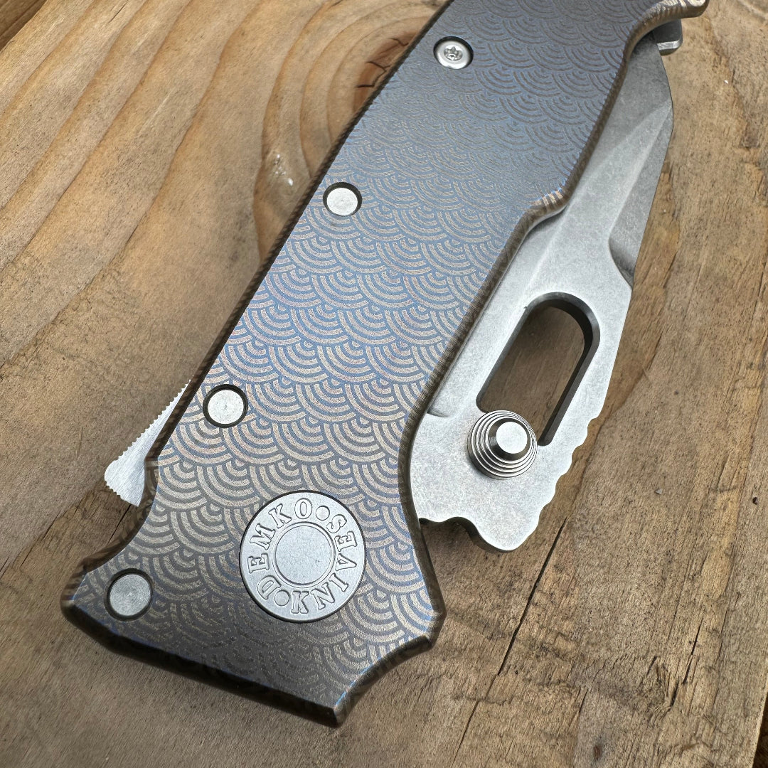 AD20 compact folding knife in the closed position, with anodized titanium laser engraved handle.