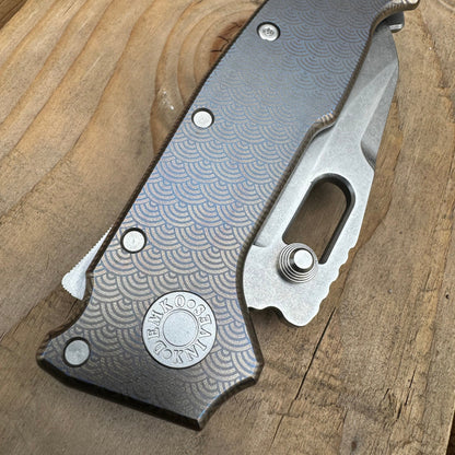 AD20 compact folding knife in the closed position, with anodized titanium laser engraved handle.