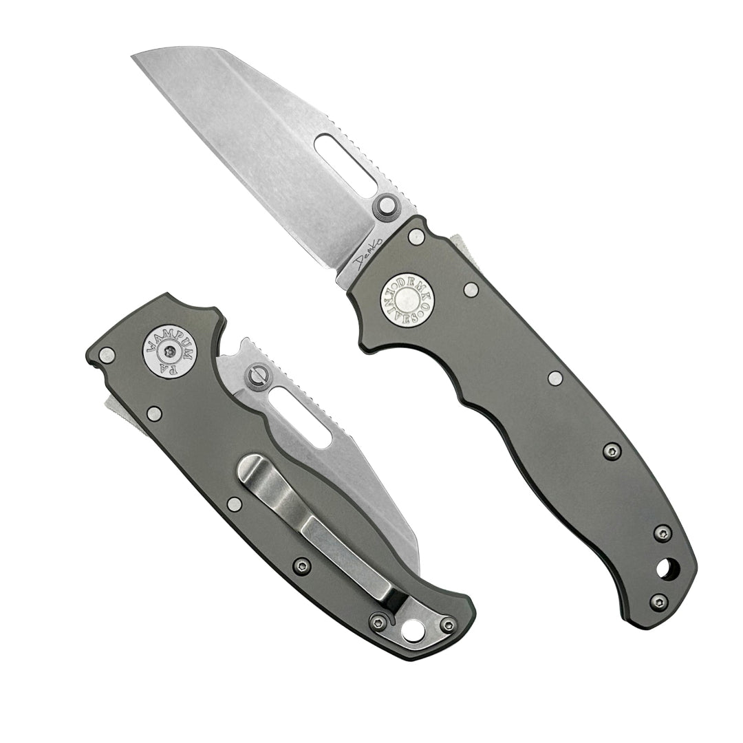 AD20.5 folding knife with a smooth titanium handle and a CPM20CV steel shark foot blade.