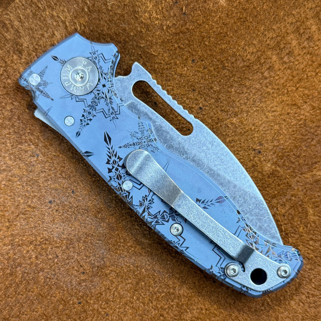 Closed AD20.5 folding knife with snowflake engraved design.