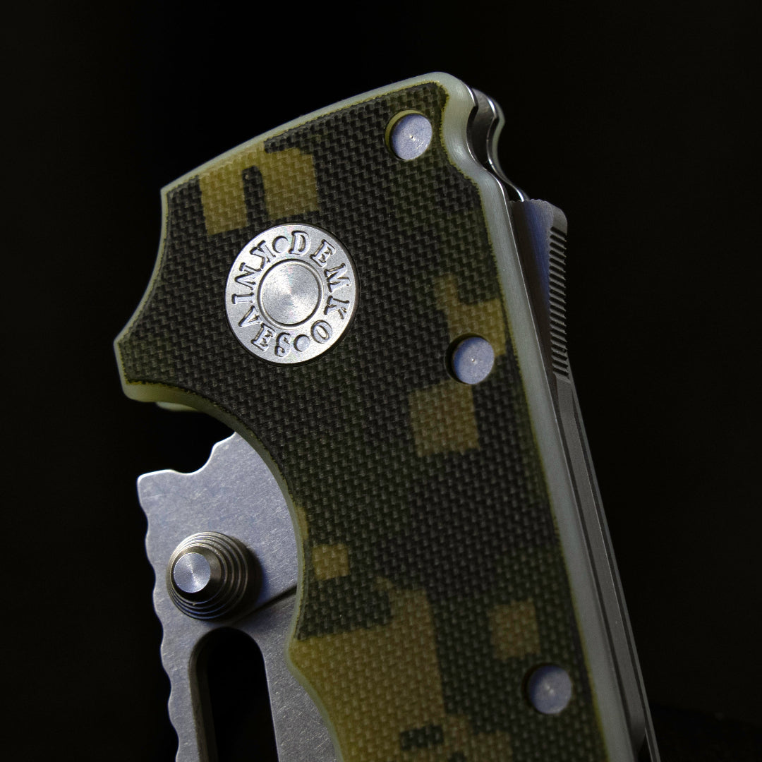 AD20I folding knife with a digital camo 1 closed showing the Demo Knives pivot pin.
