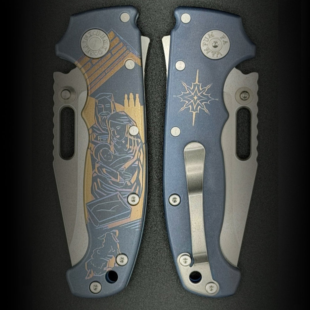 American made AD20S (Slim) folding knife with MagnaCut clip point blade, anodized smooth titanium handle, featuring a laser etch Christmas Nativity Scene.