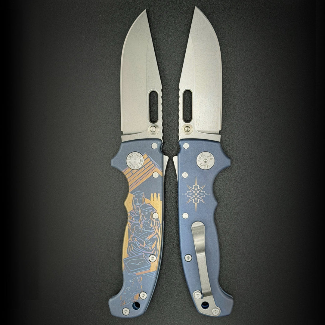 American made AD20S (Slim) folding knife with MagnaCut clip point blade, anodized smooth titanium, and laser etch nativity scene.