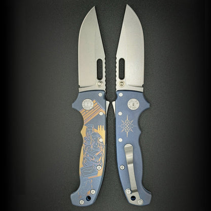 American made AD20S (Slim) folding knife with MagnaCut clip point blade, anodized smooth titanium, and laser etch nativity scene.