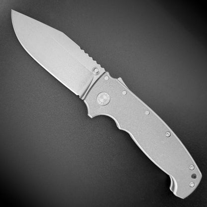 AD20 XXX folding knife with no slot clip point blade and titanium handle.