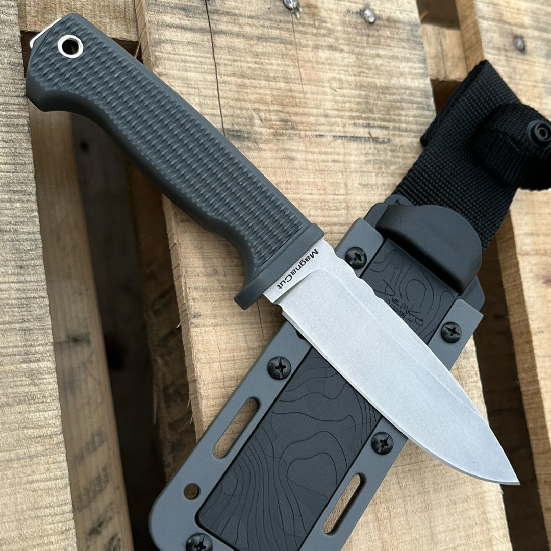 American FreeReign drop point MagnaCut fixed blade featuring a grey handle with a textured grip and sheath.
