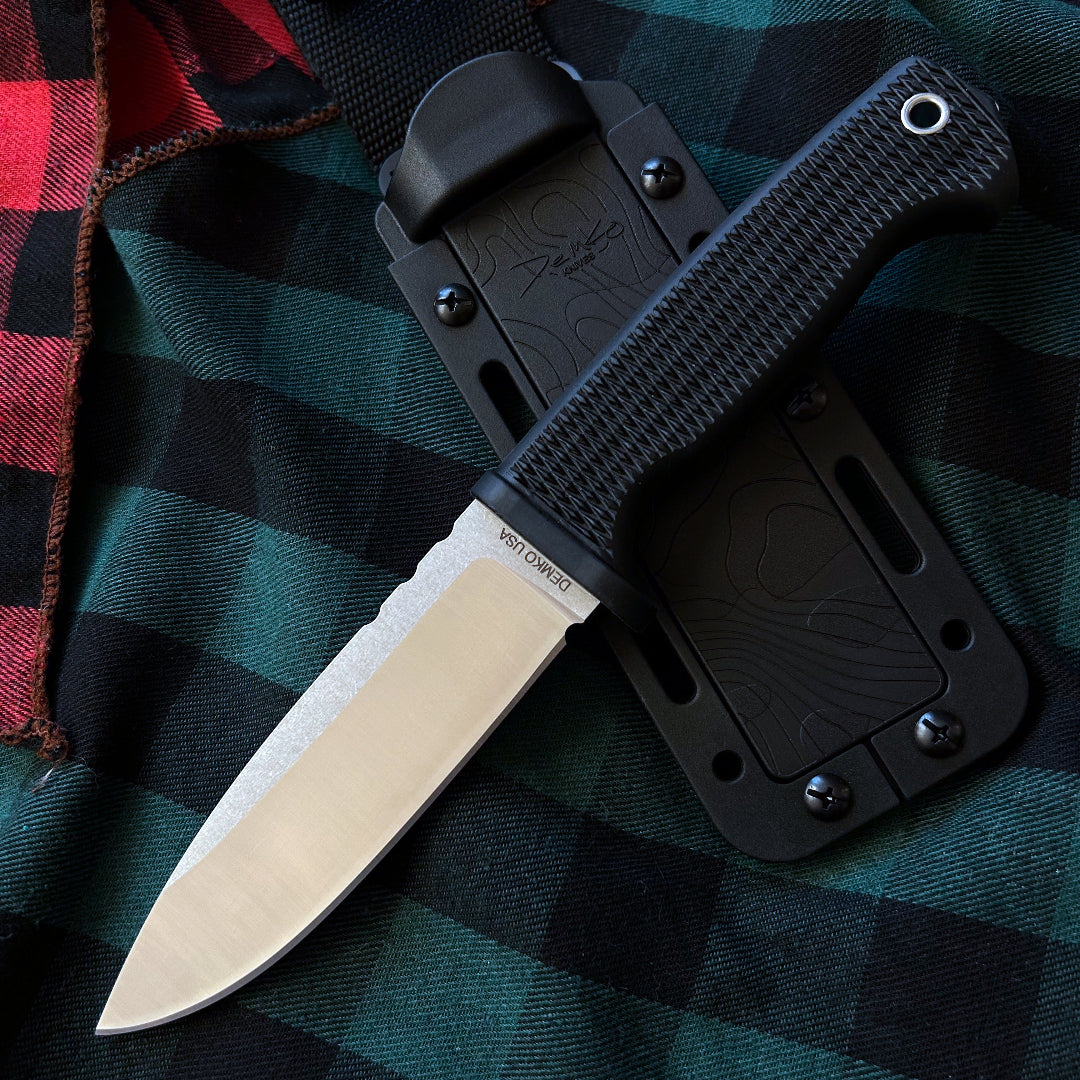 American made FreeReign fixed blade with sheath on a flannel background.