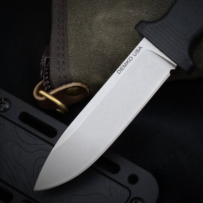 Armiger 4 fixed blade hunting knife with an black handle and sheath laying on a canvas carrying case.
