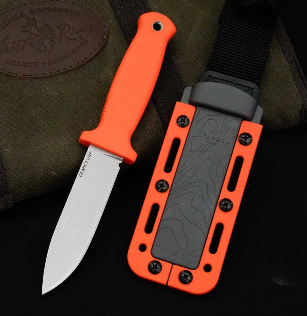 Armiger 4 fixed blade hunting knife with an Orange handle and sheath laying on a canvas carrying case.