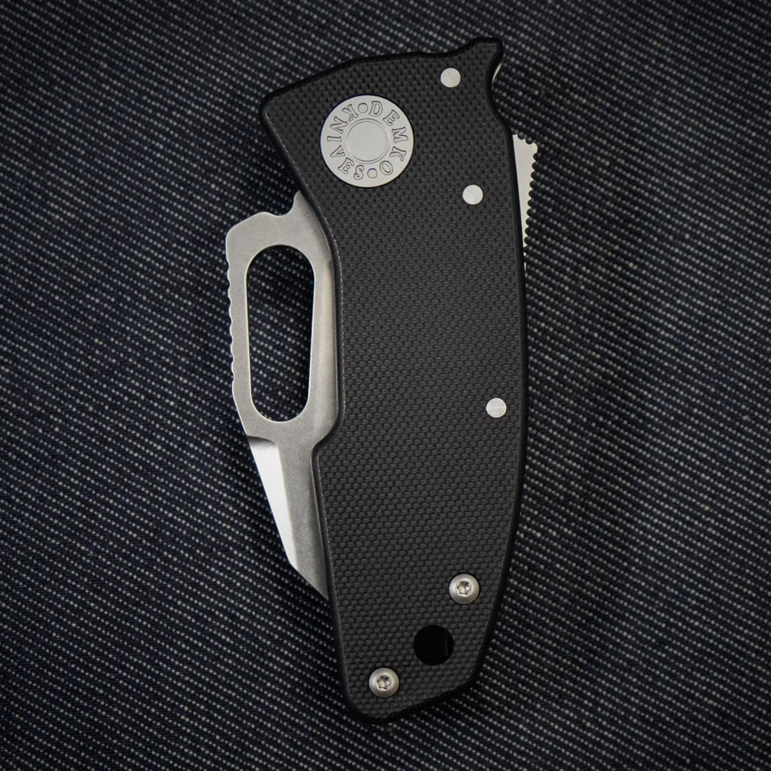 Nano-Shark folding knife with a 20CV Shark Foot blade on a dark textured background.