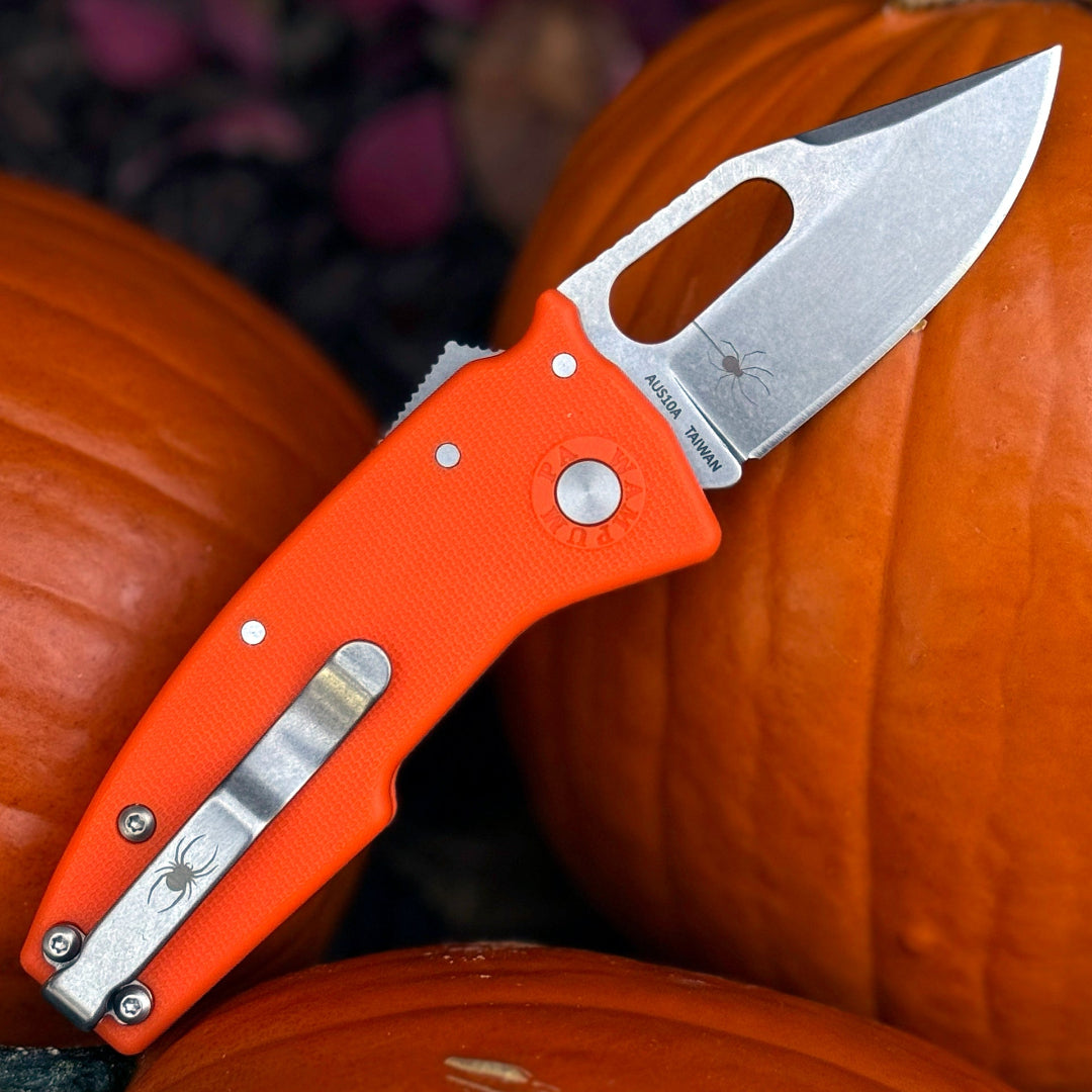 Nano-Shark folding knife with orange handle and halloween themed laser etchings on pocket clip.
