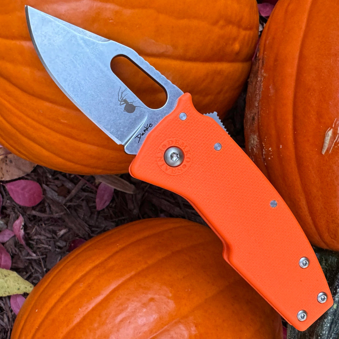 Nano-Shark folding knife with orange handle and halloween themed laser etchings.