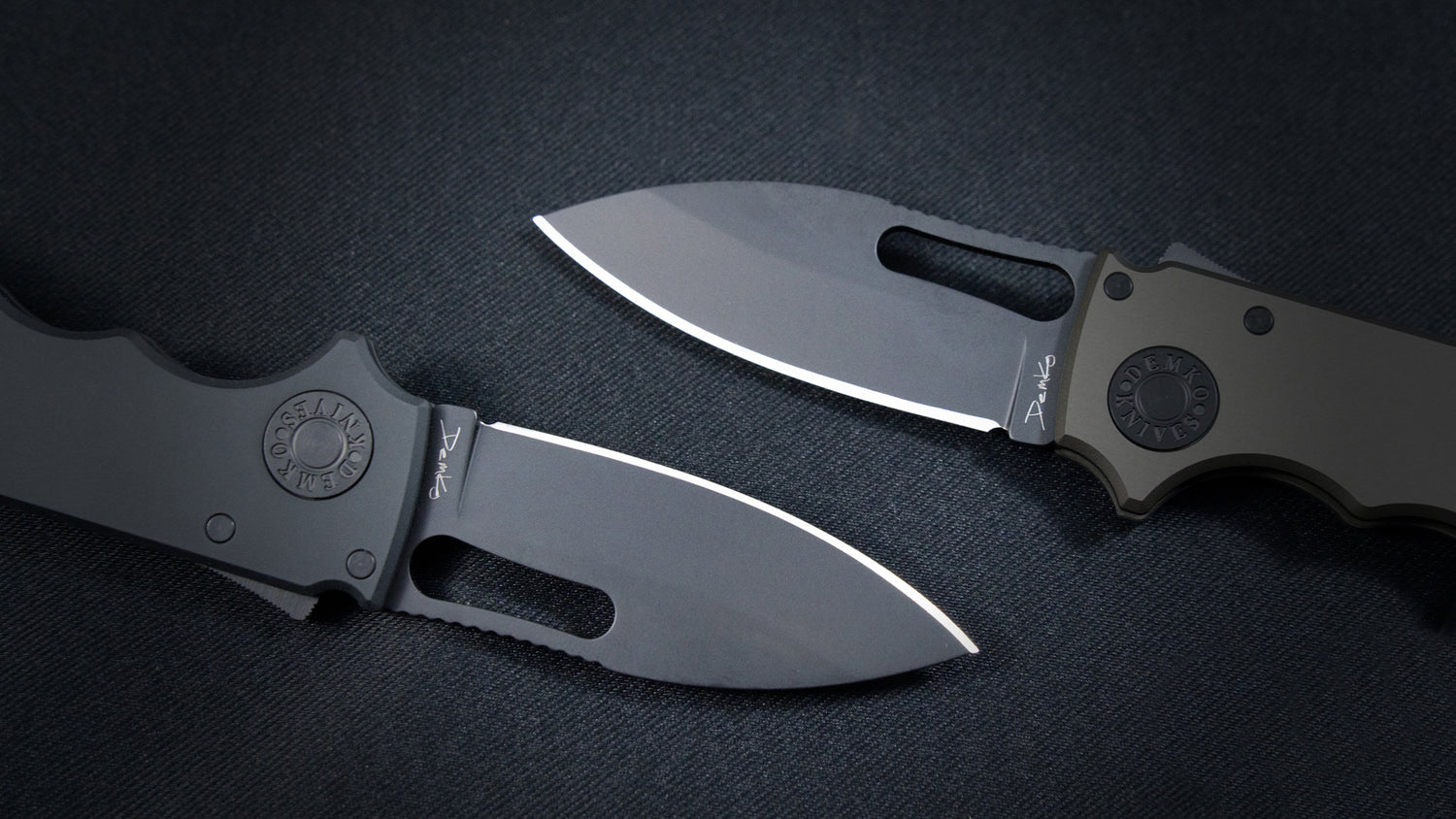 Both Shark-Cub Stealth models open laying on a canvas surface showing a close up of the slicer shark blades and pivot pins