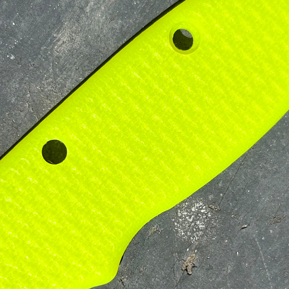 Close-up of day glow milled texture G10 replacement scales for AD20 folding knife.