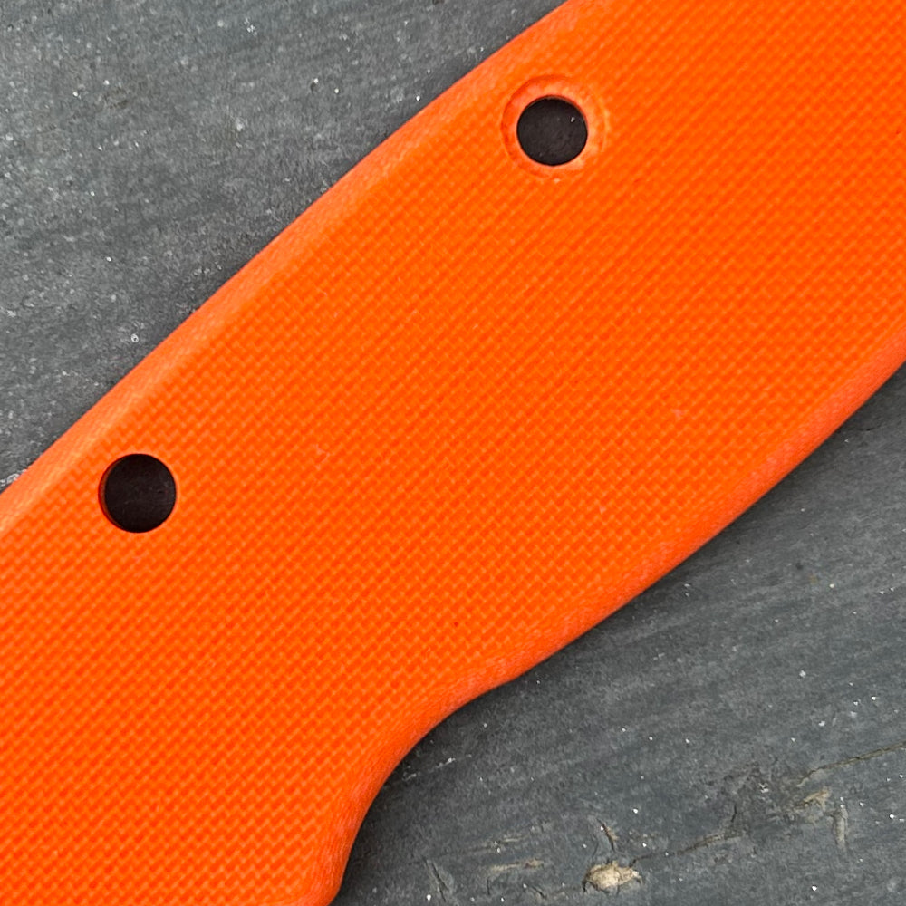 Close-up of peel ply orange G10 knife handle replacement scales.