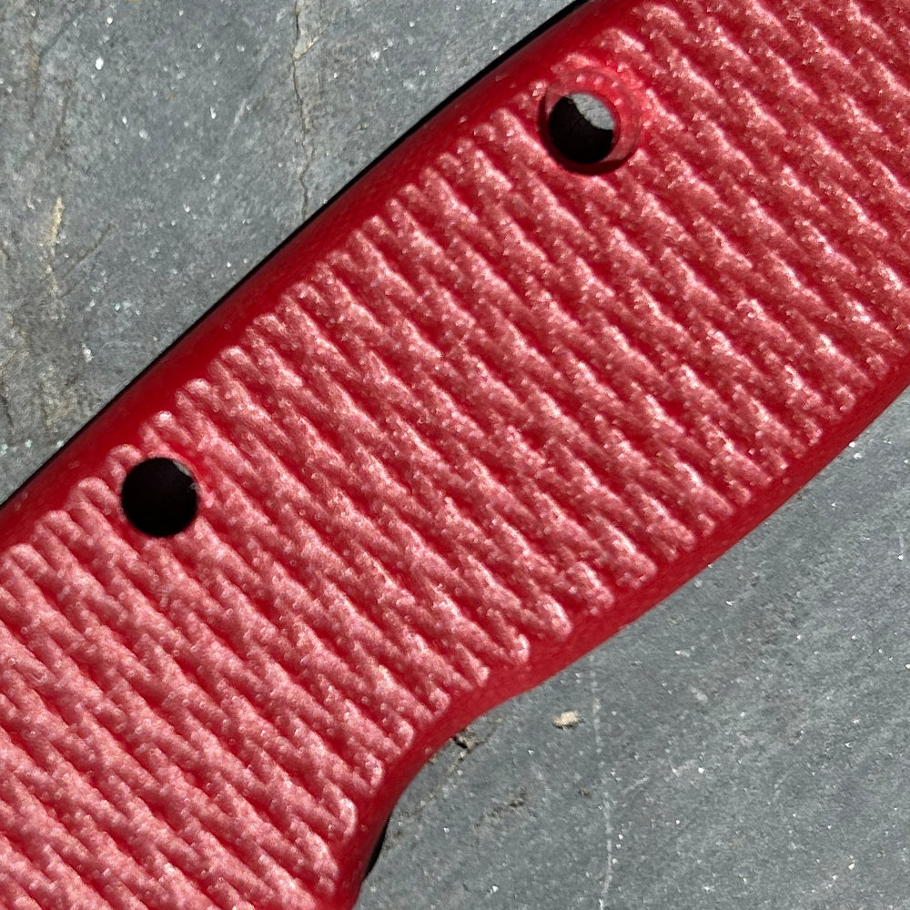 Close-up of red milled textured AD20 replacement handle scales.