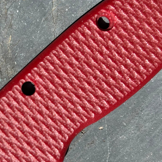 Close-up of red milled textured AD20 replacement handle scales.