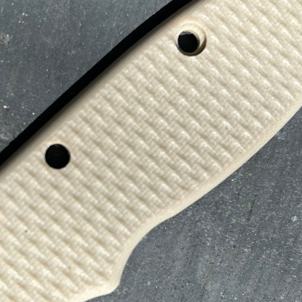 Close-up view of a tan texture G10 scales for USA-Made AD20.