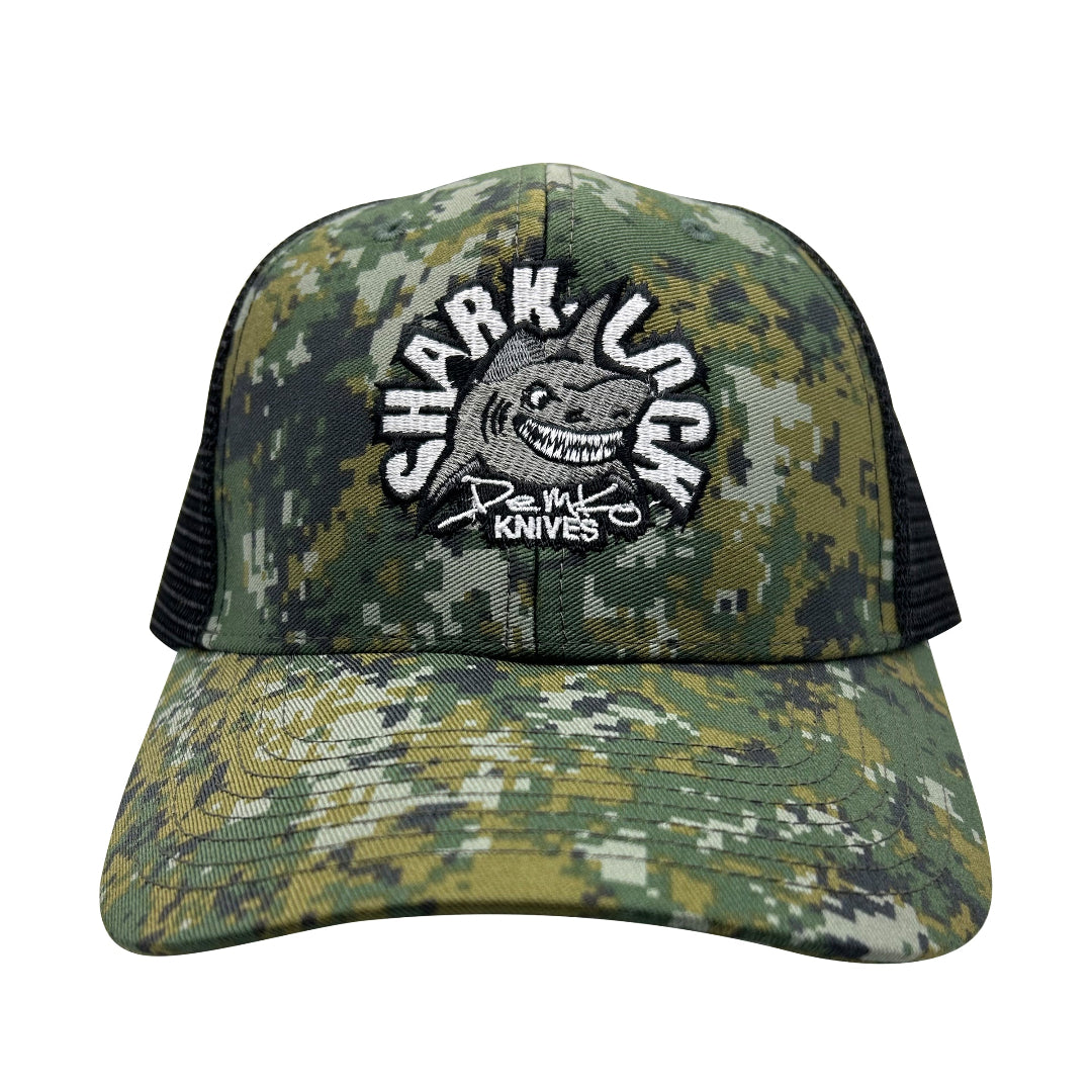 Digital-Camouflage cap with a shark-lock logo embroidered on the front.
